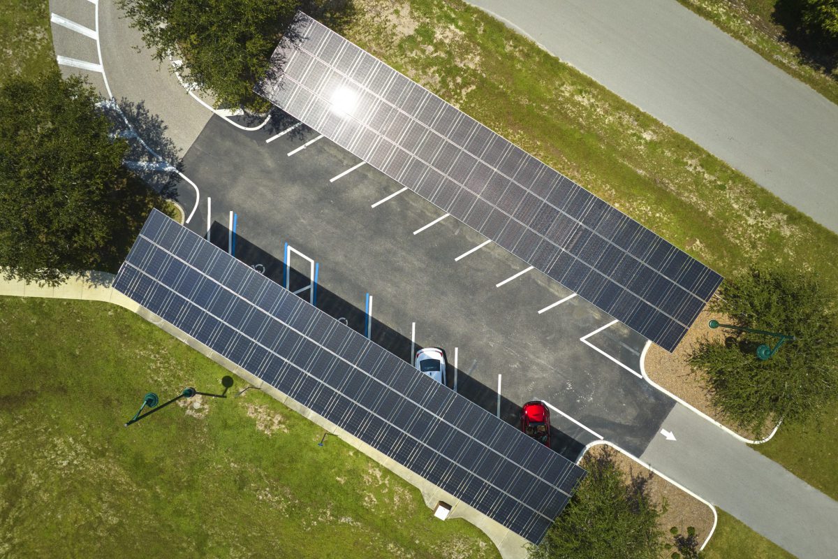 Solar panels installed over parking lot for parked cars for effective generation of clean energy.